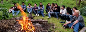 Youth singing around campfire
